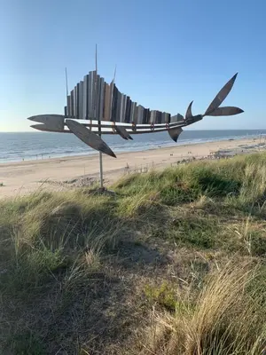 a sculpture on the beach near a beach at Studio South Beach II with free parking in Zandvoort
