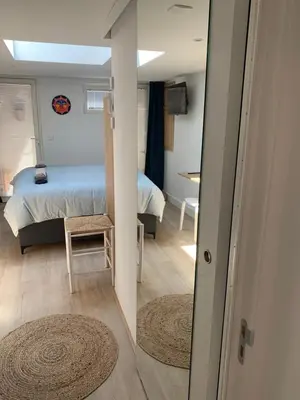 a view of a bedroom with a bed and a mirror at Studio South Beach II with free parking in Zandvoort