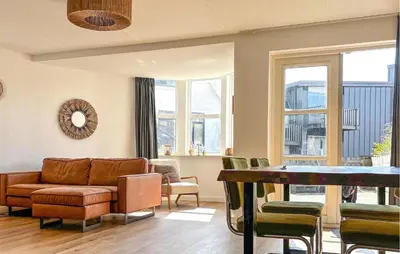 a living room with a couch and a table at Nice Apartment In Bergen Aan Zee in Bergen aan Zee
