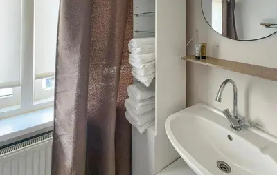 a bathroom with a sink and a shower curtain at 1 Bedroom Awesome Home In Katwijk Aan Zee in Katwijk aan Zee