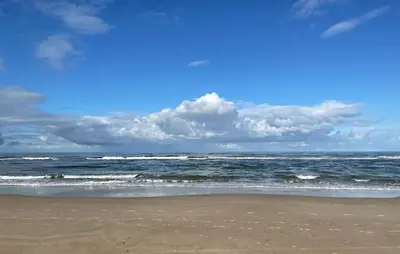 a beach with the ocean on a cloudy day at 1 Bedroom Awesome Home In Katwijk Aan Zee in Katwijk aan Zee