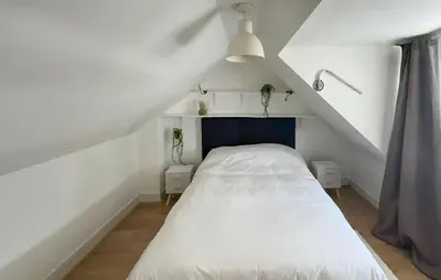 a bedroom with a white bed in a attic at 1 Bedroom Awesome Home In Katwijk Aan Zee in Katwijk aan Zee