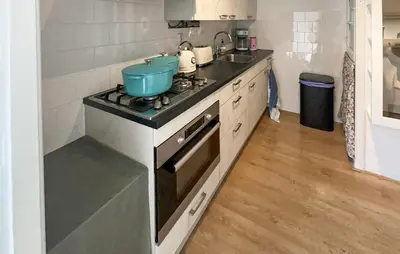 a kitchen with a stove with a blue bowl on it at 1 Bedroom Awesome Home In Katwijk Aan Zee in Katwijk aan Zee