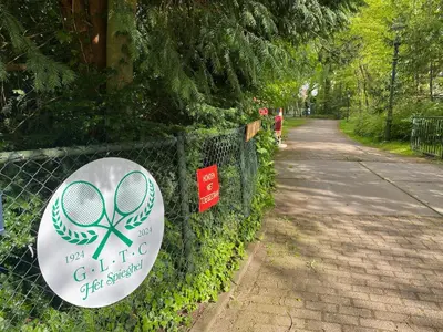 a sign on a fence with a tennis racket on it at Authentic villa near Amsterdam and nature in Ons Belang
