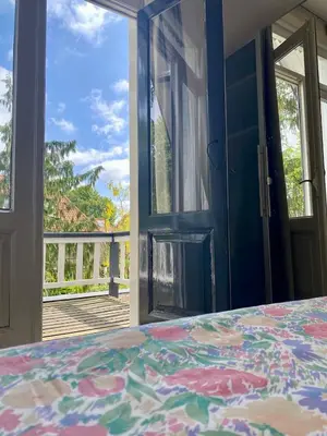 a bedroom with a door open to a porch with a bed at Authentic villa near Amsterdam and nature in Ons Belang