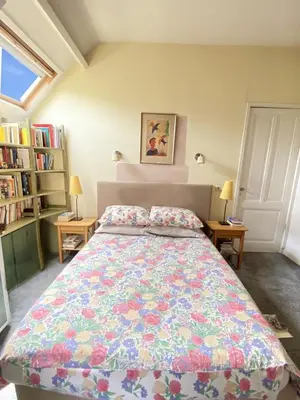 a bedroom with a large bed with a floral bedspread at Authentic villa near Amsterdam and nature in Ons Belang