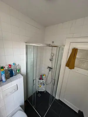 a bathroom with a shower with a glass door at michelle in Amsterdam