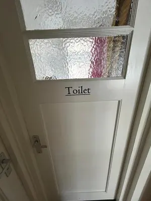 a skylight on a door with the word toilet at michelle in Amsterdam