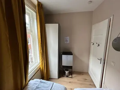 a small room with a bed and a window at michelle in Amsterdam