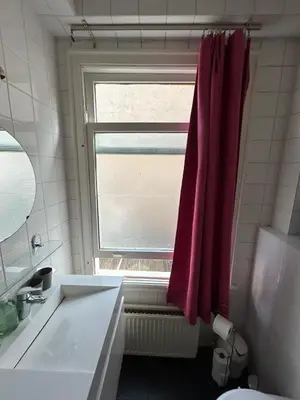 a bathroom with a sink and a window at michelle in Amsterdam