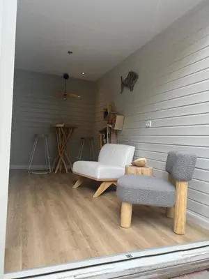 a living room with two chairs and a couch at Zandvoort Boutique Apartments in Zandvoort