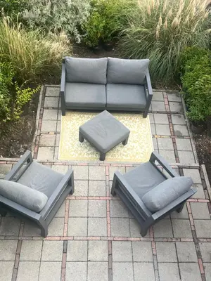 three chairs and a couch on a patio at Zandvoort Boutique Apartments in Zandvoort