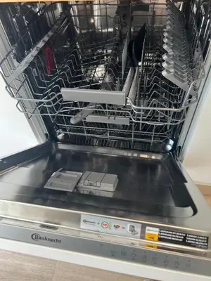a dishwasher with a rack full of utensils at Zandvoort Boutique Apartments in Zandvoort
