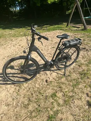 a bike parked on the ground in the grass at Zandvoort Boutique Apartments in Zandvoort