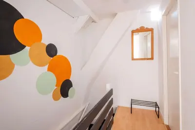 a staircase with a painting on the wall at Stay de Laat in Alkmaar