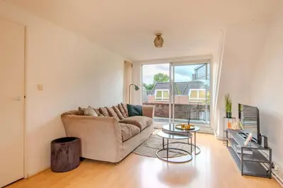a living room with a couch and a table at Stay de Laat in Alkmaar