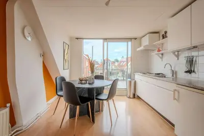 a kitchen with a table and chairs in a room at Stay de Laat in Alkmaar