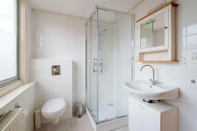a bathroom with a toilet and a sink and a shower at Stay de Laat in Alkmaar