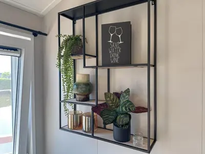 a glass shelf in a living room with a plant at Fuut 24-28 in Breukelen