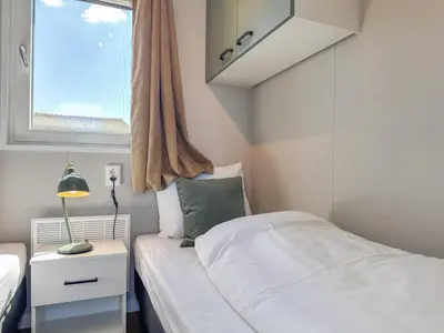 a small bedroom with a bed and a window at Fuut 24-28 in Breukelen