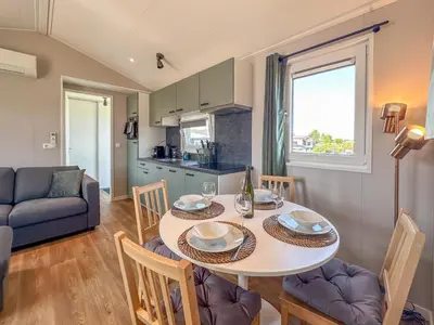 a kitchen and living room with a table and chairs at Fuut 24-26 in Breukelen