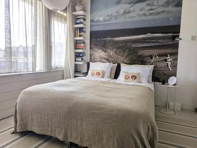 a bedroom with a bed with two teddy bears on the pillows at Studio Lumare-Inn in Bergen aan Zee