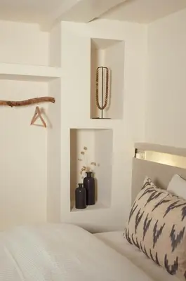 a white bedroom with a bed and a mirror at Luxury canal suite in the best location of Amsterdam !!! in Amsterdam