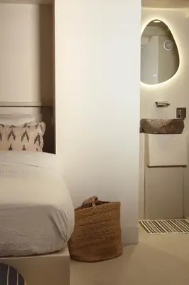 a white bedroom with a bed and a mirror at Luxury canal suite in the best location of Amsterdam !!! in Amsterdam