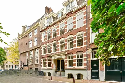 a large brick building on the side of a street at Luxury canal suite in the best location of Amsterdam !!! in Amsterdam