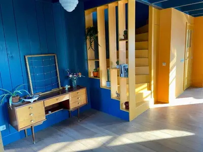 a blue room with a sink and a mirror at House next to Amsterdam in Landsmeer