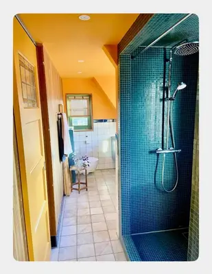 a bathroom with a shower with a glass door at House next to Amsterdam in Landsmeer