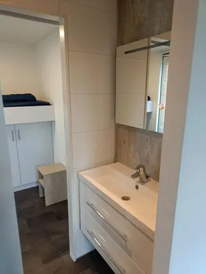 a bathroom with a sink and a mirror at Holiday home - area AMSTERDAM - 6 people in Halfweg