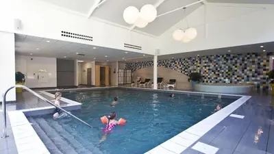 a group of people in a swimming pool at Holiday home - area AMSTERDAM - 6 people in Halfweg