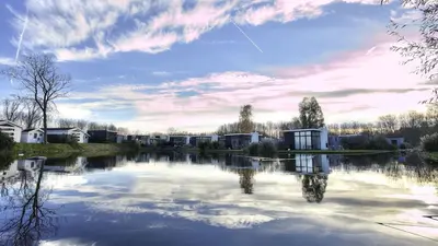 a large body of water with houses and buildings at Holiday home - area AMSTERDAM - 6 people in Halfweg