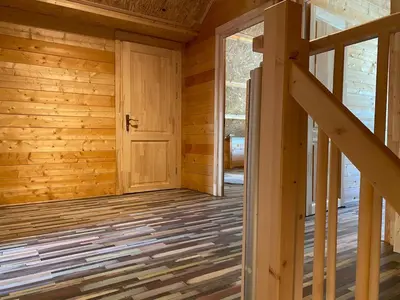 an empty room with a door in a log cabin at The blue house in Roelofarendsveen