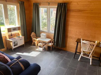 a living room with a table and chairs and a couch at The blue house in Roelofarendsveen