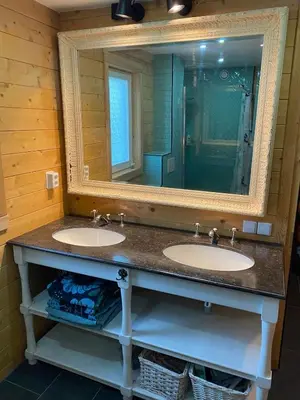 a bathroom with two sinks and a large mirror at The blue house in Roelofarendsveen
