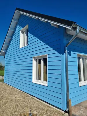 a blue house with two windows at The blue house in Roelofarendsveen