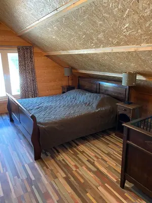 a bedroom with a large bed in a room at The blue house in Roelofarendsveen