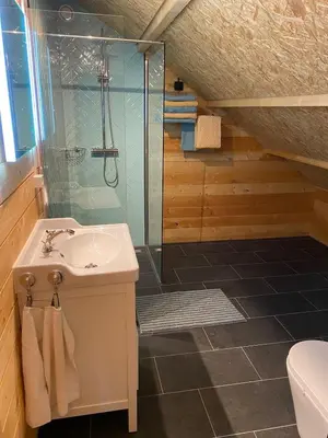 a bathroom with a sink and a glass shower at The blue house in Roelofarendsveen