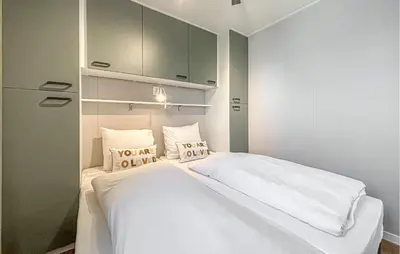 a bedroom with a bed with white sheets and pillows at Gorgeous Home In Breukelen With House Sea View in Breukelen