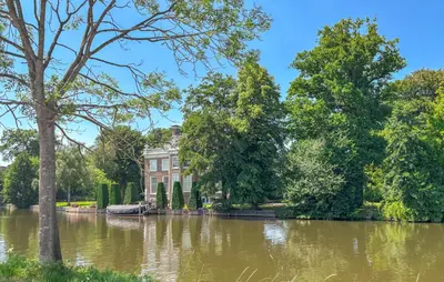 a house in the middle of a river with trees at Gorgeous Home In Breukelen With House Sea View in Breukelen