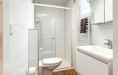 a white bathroom with a toilet and a sink at Nice Home In Breukelen in Breukelen