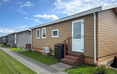a row of mobile homes with a porch and a door at Nice Home In Breukelen in Breukelen