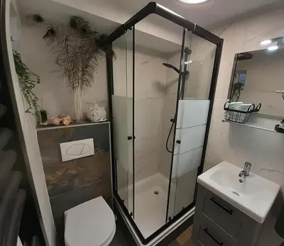 a bathroom with a shower and a toilet and a sink at Eeden in Noordwijk aan Zee