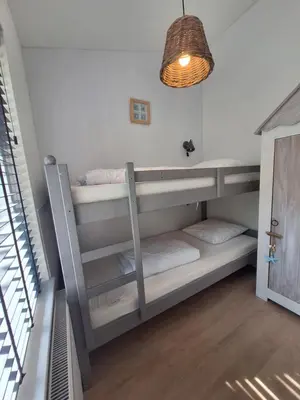 a bedroom with two bunk beds in a room at Rekerlanden 133 in Warmenhuizen