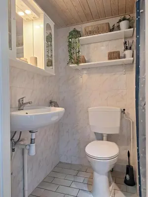 a bathroom with a toilet and a sink at Rekerlanden 133 in Warmenhuizen
