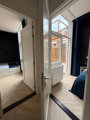 an open door to a room with a window at The Blue House in Alkmaar