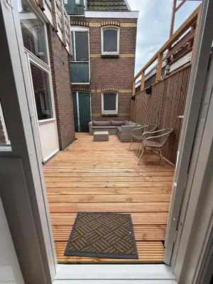 an open door to a balcony with a wooden deck at The Blue House in Alkmaar