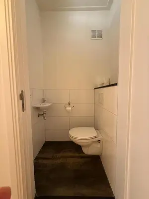 a small bathroom with a toilet and a sink at The Blue House in Alkmaar